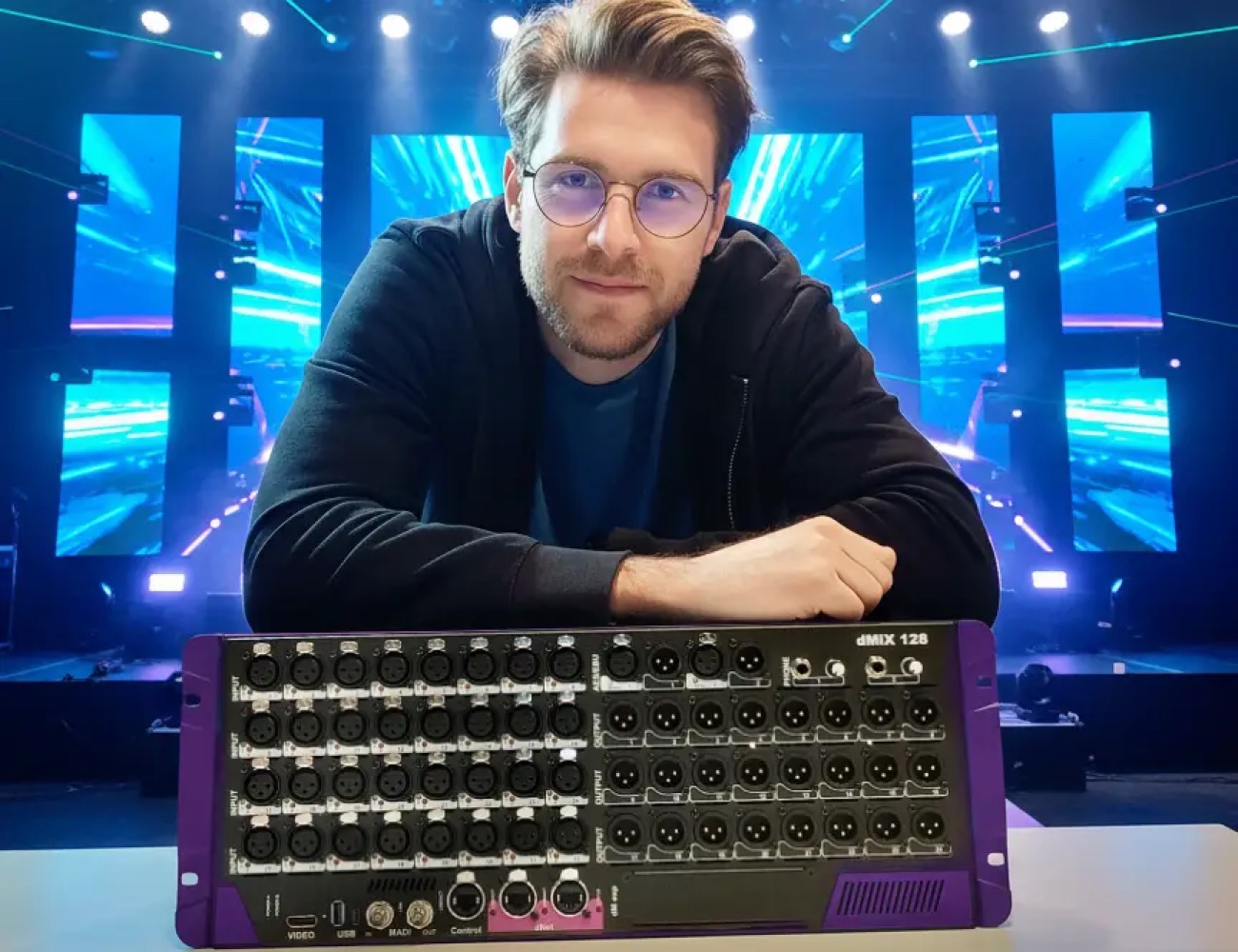 Sound engineer with a Violet Audio dMix 128 on a live event stage